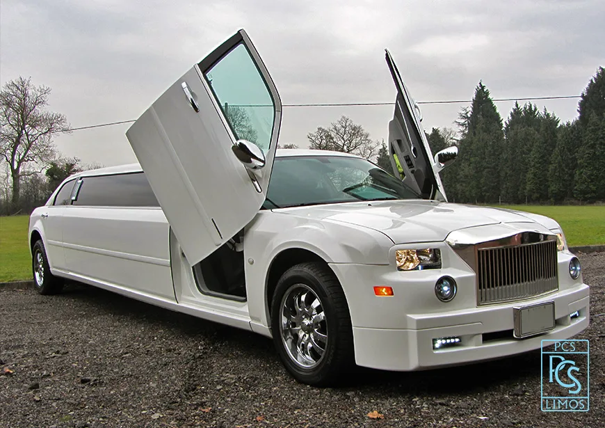 Full exterior length view of white stretch limousine
