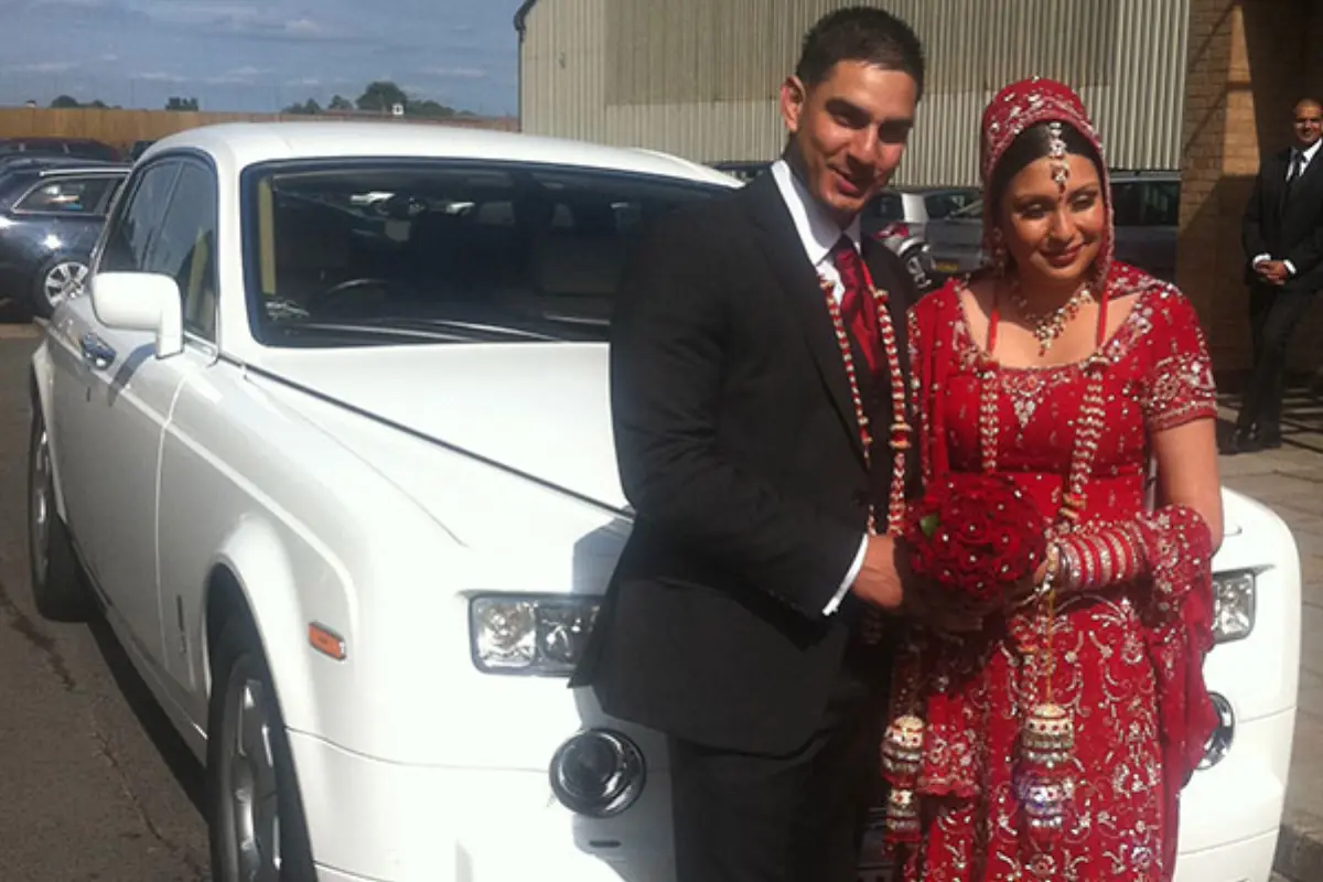Wedding couple with their car