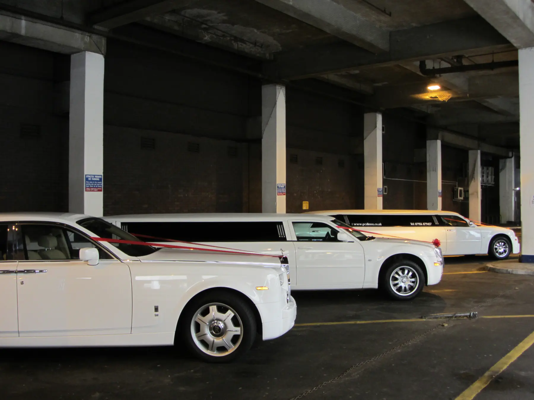 Fleet of three white wedding vehicles including Rolls-Royce Phantom and stretch limousines