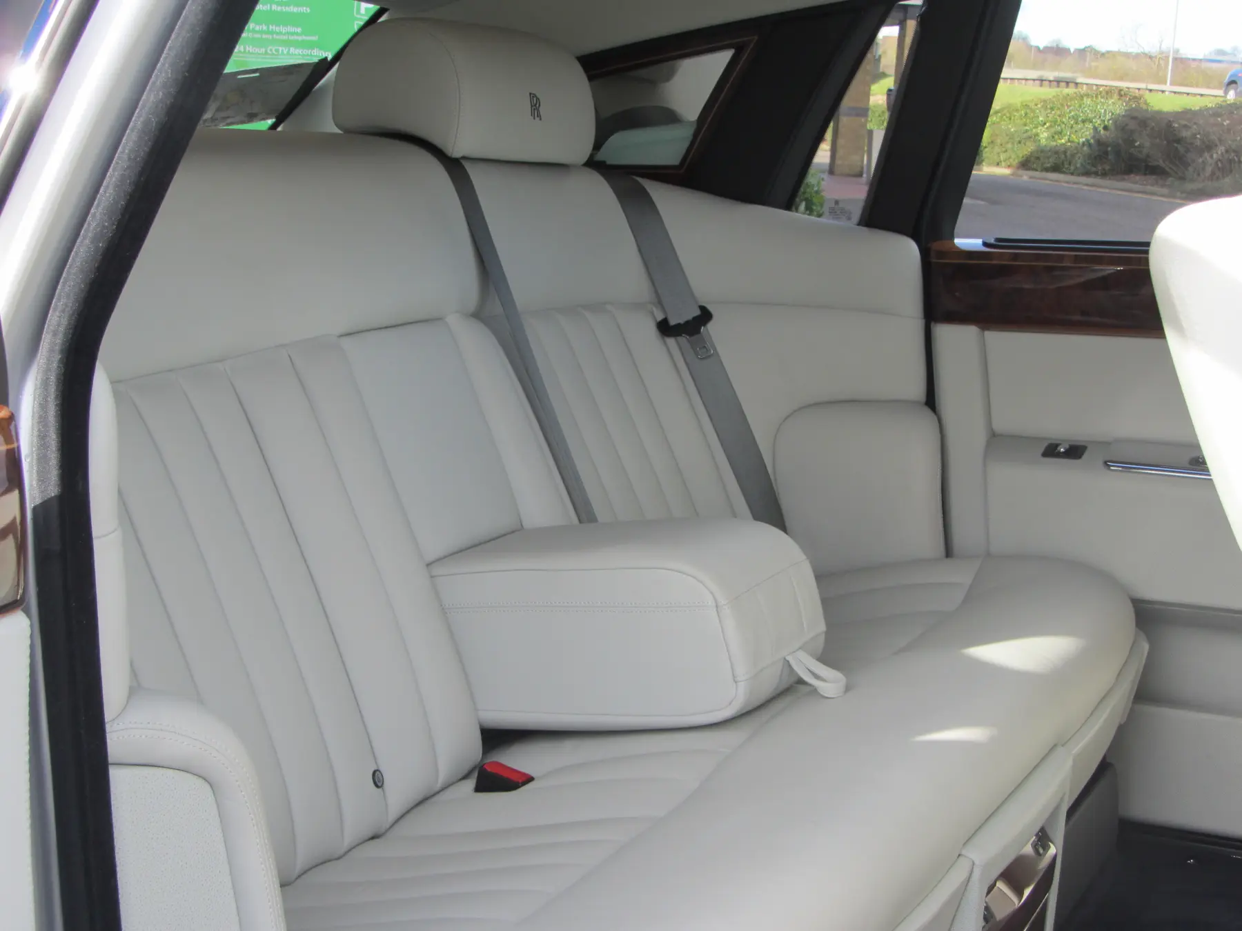 Rear passenger cabin of Rolls-Royce Phantom with cream leather seating and embroidered RR headrests