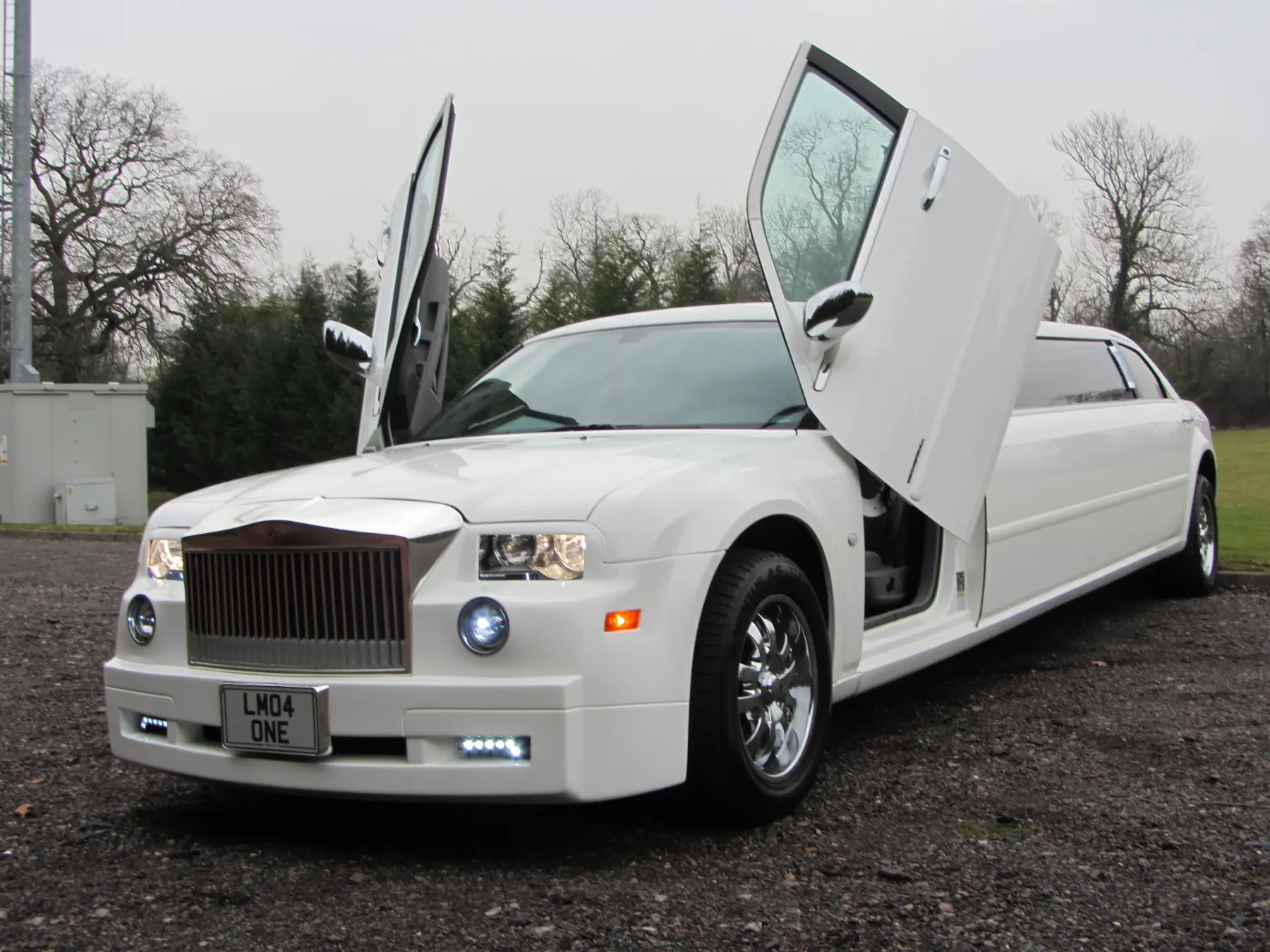White Rolls-Royce style stretch limousine with front Lambo scissor doors raised